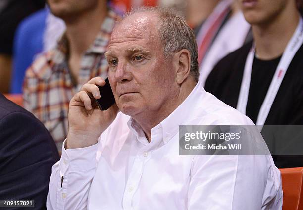 Uli Hoeness, club president of Muenchen answers a phone call during game one of the 2014 Beko BBL Playoffs semifinals between FC Bayern Muenchen and...