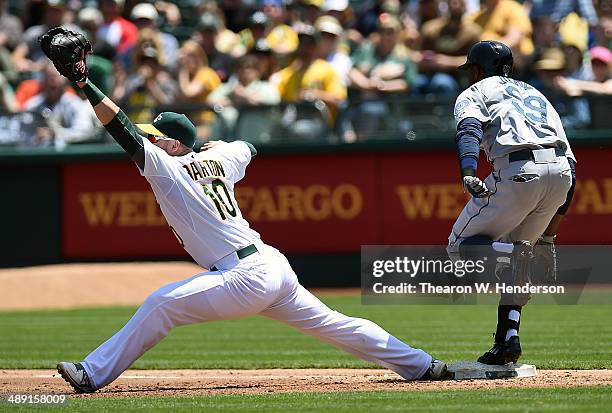 James Jones of the Seattle Mariners gets an infield hit, beating the throw to Daric Barton of the Oakland Athletics in the top of the third inning...