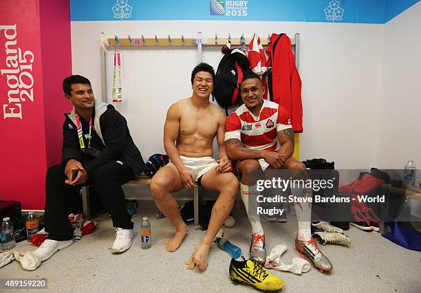 Harumichi Tatekawa and MaLe Sau of Japan celebrate their surprise victory in the dressing room following the 2015 Rugby World Cup Pool B match...