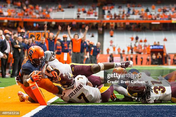 Jordan Fredericks of the Syracuse Orange dives in for a touchdown in overtime to win the game against the Central Michigan Chippewas on September 19,...