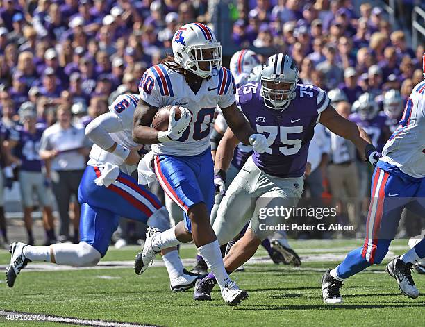 Wide receiver Kam McKnight of the Louisiana Tech Bulldogs rushes to the outside against defensive end Jordan Willis of the Kansas State Wildcats...