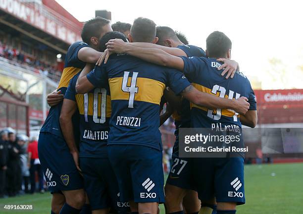 Carlos Tevez of Boca Juniors and teammates celebrate their team's first goal during a match between Argentinos Juniors and Boca Juniors as part of...