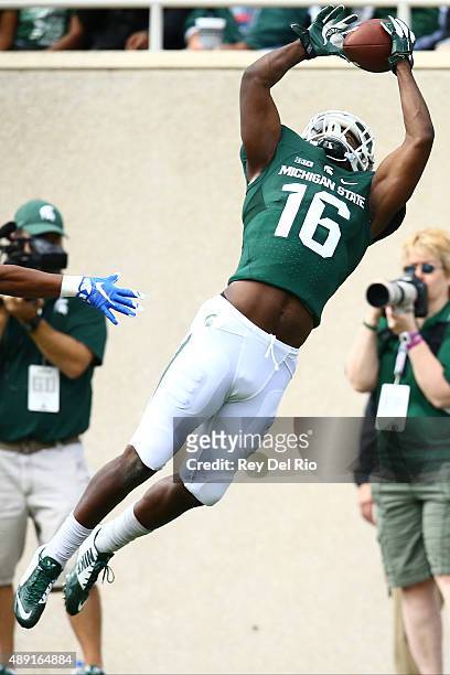 Aaron Burbridge of the Michigan State Spartans makes a catch for a touchdown against the Air Force Falcons at Spartan Stadium on September 19, 2015...