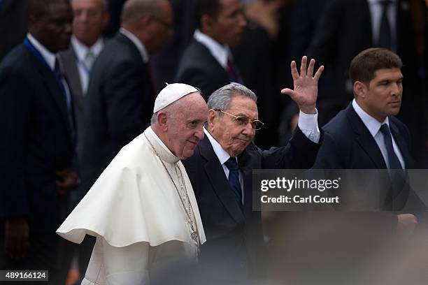 Cuba's President Raul Castro waves as he walks with Pope Francis after his arrival at Jose Marti International Airport on September 19, 2015 in...