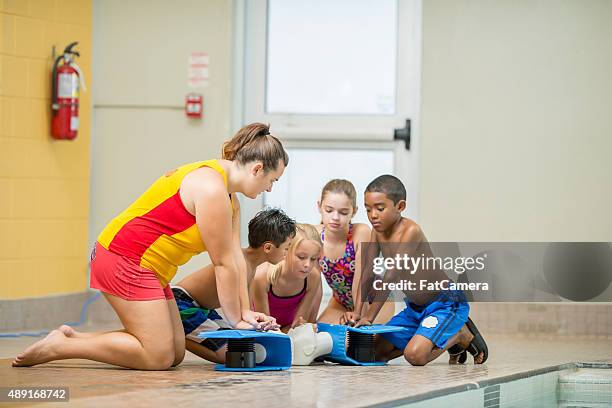 children practicing cpr - life guard stock pictures, royalty-free photos & images