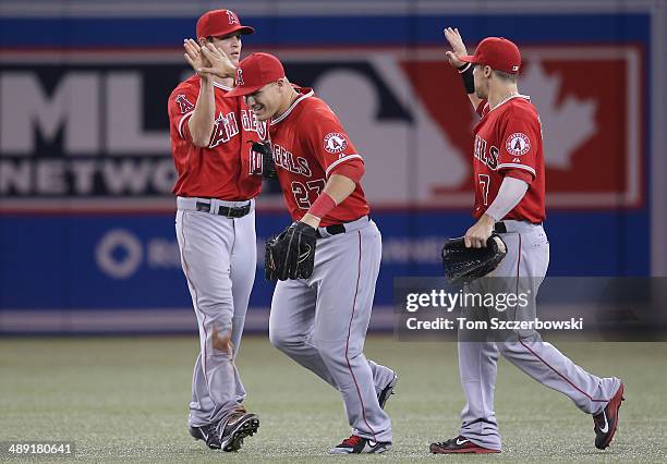 Mike Trout of the Los Angeles Angels of Anaheim celebrates their victory with Grant Green and Collin Cowgill during MLB game action against the...
