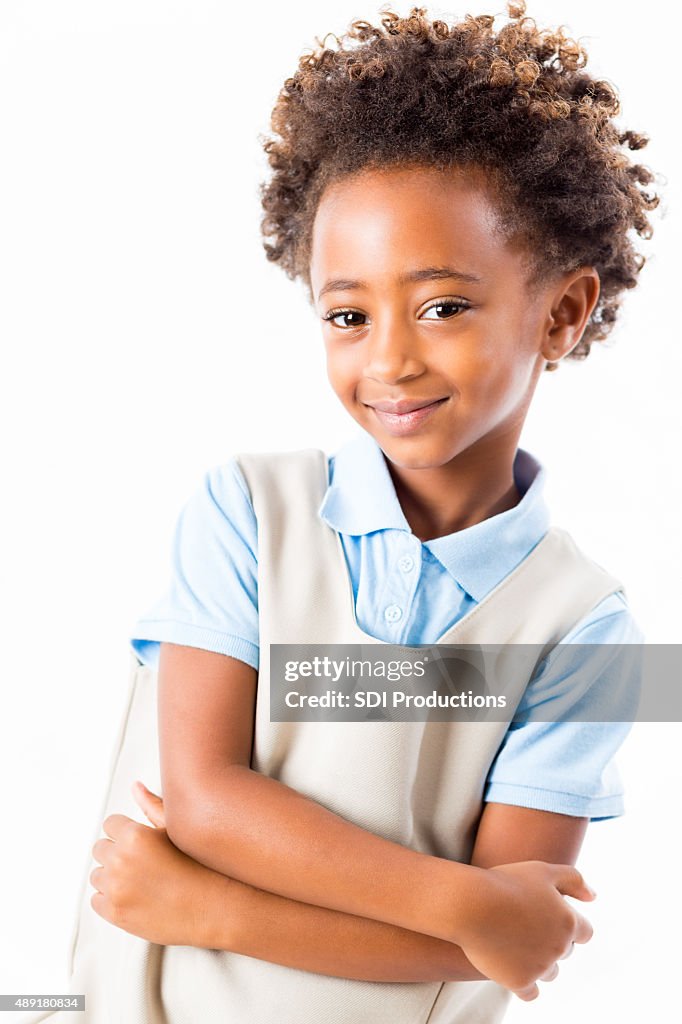 Studio shot of African American private elementary schoolgirl in uniform