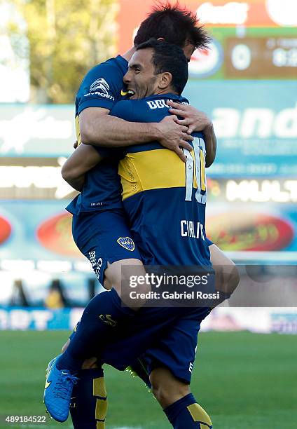 Carlos Tevez of Boca Juniors celebrates with Nicolás Lodeiro after scoring his team's second goal during a match between Argentinos Juniors and Boca...