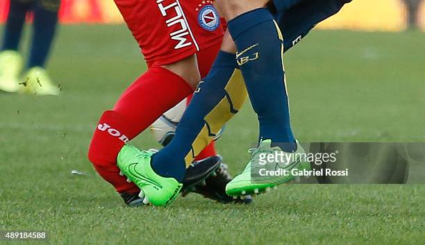 Ezequiel Ham of Argentinos Juniors is fouled and injured by Carlos Tevez of Boca Juniors during a match between Argentinos Juniors and Boca Juniors...