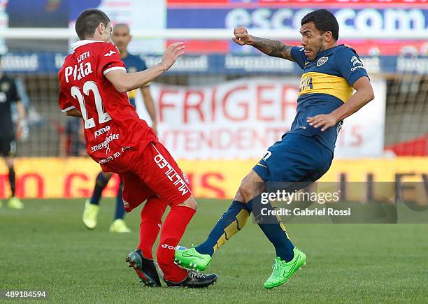 Ezequiel Ham of Argentinos Juniors is fouled and injured by Carlos Tevez of Boca Juniors during a match between Argentinos Juniors and Boca Juniors...