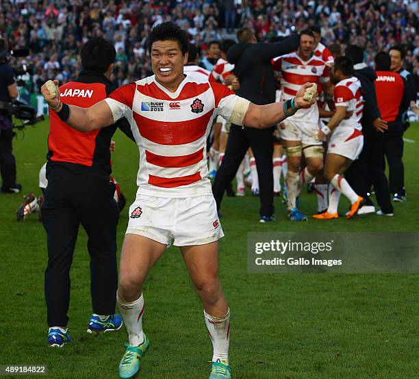 Japanese players celebrate their win during the Rugby World Cup 2015 Pool B match between South Africa and Japan at Brighton Community Centre on...