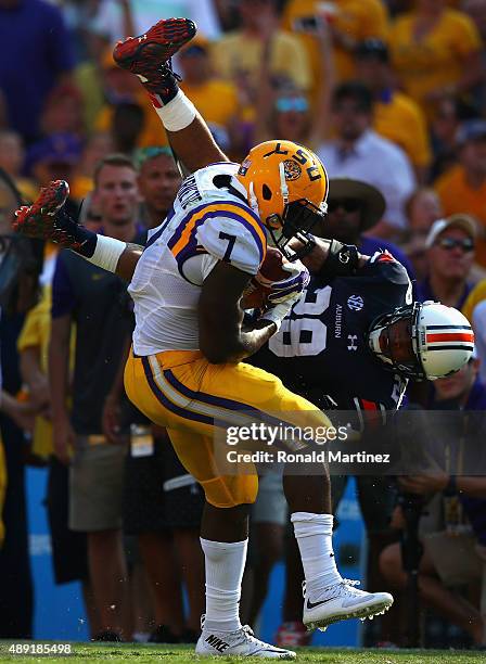 Leonard Fournette of the LSU Tigers runs past the attempted tackle by Tray Matthews of the Auburn Tigers at Tiger Stadium on September 19, 2015 in...