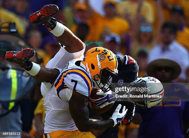 Leonard Fournette of the LSU Tigers runs past the attempted tackle by Tray Matthews of the Auburn Tigers at Tiger Stadium on September 19, 2015 in...