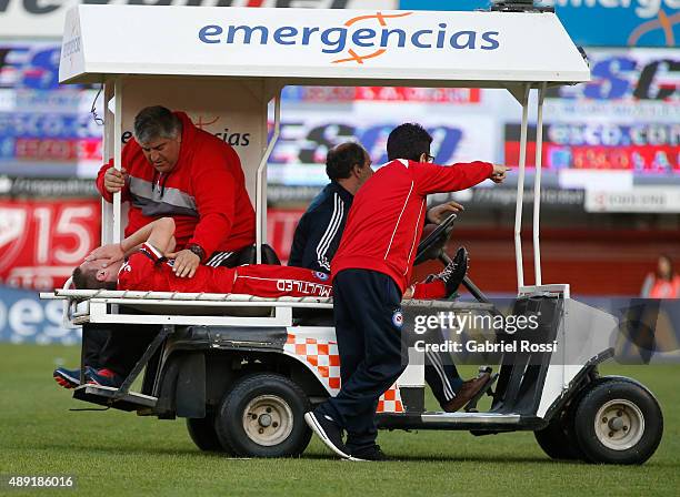 Ezequiel Ham of Argentinos Juniors leaves the field after receiving a foul from Carlos Tevez of Boca Juniors during a match between Argentinos...