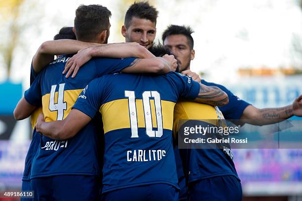 Carlos Tevez of Boca Juniors celebrates with teammates after scoring his team's second goal during a match between Argentinos Juniors and Boca...
