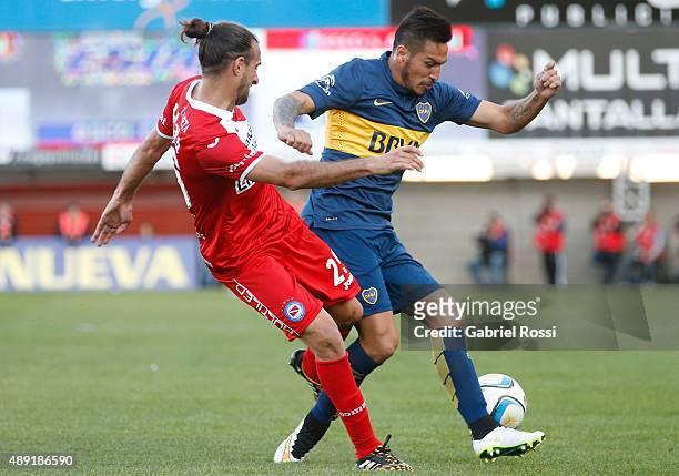 Fabian Monzon of Boca Juniors fights for the ball with Joaquin Laso of Argentinos Juniors during a match between Argentinos Juniors and Boca Juniors...