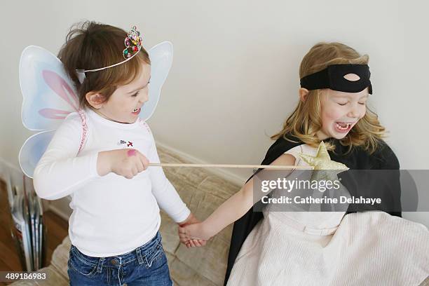 two disguides children playing together - boy wearing dress photos et images de collection