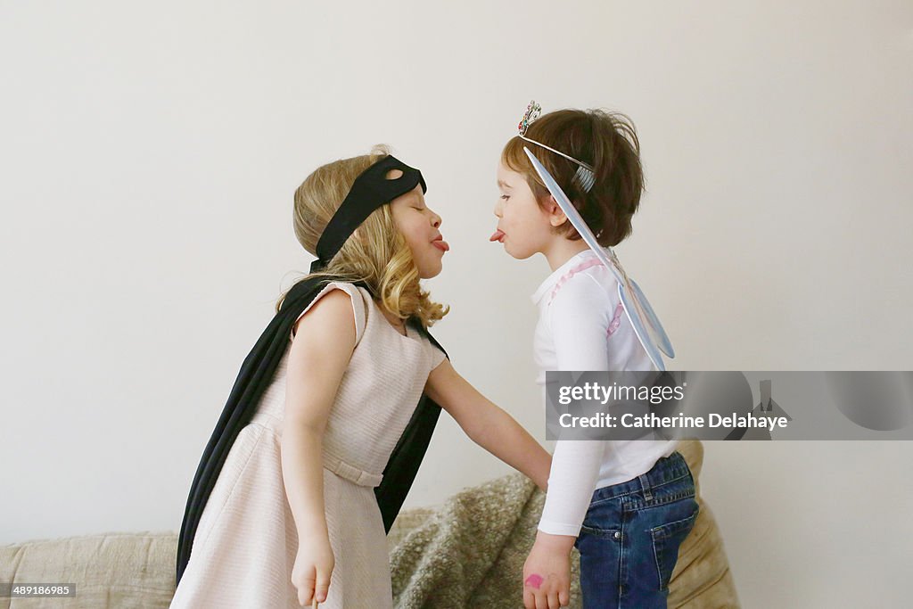 Two disguides children playing together