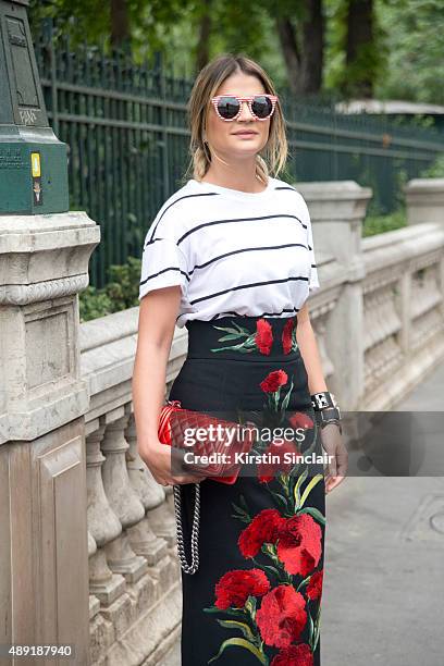 Fashion blogger Thassia Naves wears a Dolce and Gabbana skirt, H and M T shirt, Miu Miu shoes, Illesteva sunglasses and a Chanel bag on day 4 of...