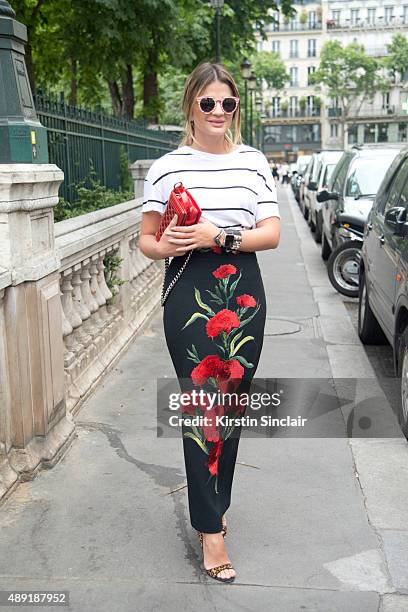 Fashion blogger Thassia Naves wears a Dolce and Gabbana skirt, H and M T shirt, Miu Miu shoes, Illesteva sunglasses and a Chanel bag on day 4 of...