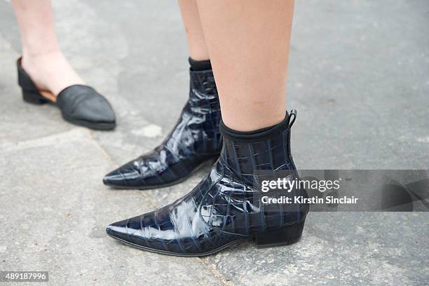 Fashion writer and blogger Susie Lau wears a Louis Vuitton top, shoes and bag, Balenciaga skirt, and a Fendi fur letter bag Pom Pom on day 4 of Paris...