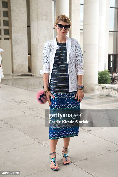 Fashion Stylist Elisa Nalin wears a Dries Van Noten skirt, Equipment shirt, a Roger Vivier bag, vintage Ralph Lauren top, Dita sunglasses, Fendi fur...