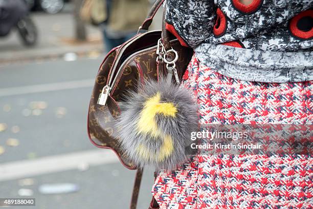 Fashion writer and blogger Susie Lau wears a Louis Vuitton top, shoes and bag, Balenciaga skirt, and a Fendi fur letter bag Pom Pom on day 4 of Paris...