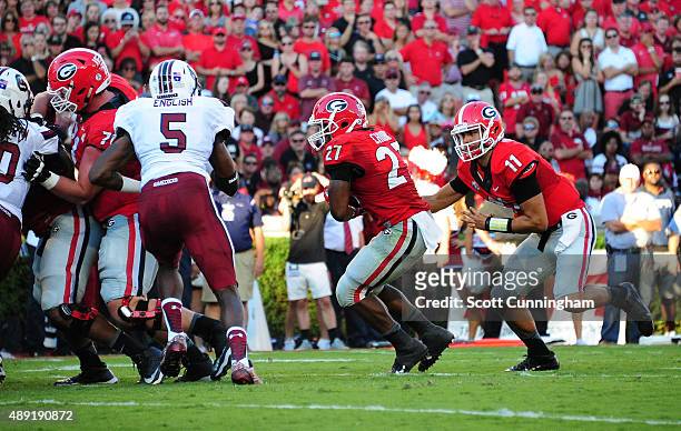 Nick Chubb of the Georgia Bulldogs takes a handoff from Greyson Lambert to score a second quarter touchdown against South Carolina Gamecocks on...