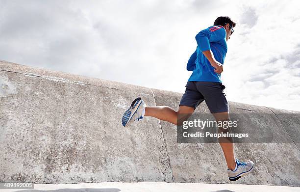 feeling good and keeping fit! - male jogging stock pictures, royalty-free photos & images