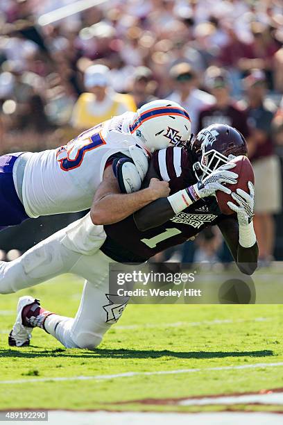 De'Runnya Wilson of the Mississippi State Bulldogs reaches out for a touchdown but his knee hits down at the one while being tackled by Peyton Guidry...