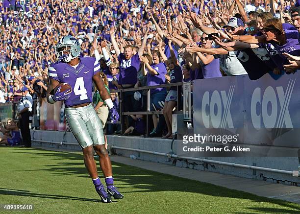 Wide receiver Dominique Heath of the Kansas State Wildcats looks on, as Wildcat fans react, after catching a touchdown pass against the Louisiana...