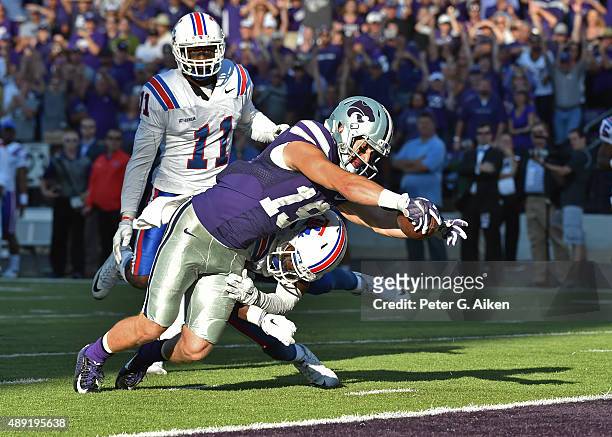Wide receiver Kody Cook of the Kansas State Wildcats dives into the end zone after catching a 31-yard touchdown pass against the Louisiana Tech...