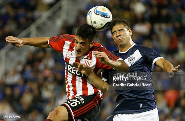Diego Mendoza of Estudiantes fights for the ball with Tiago Flores of Velez Sarsfield during a match between Velez Sarsfield and Estudiantes as part...