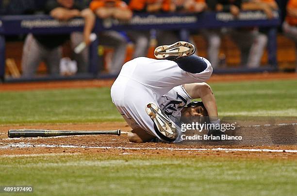 Grady Sizemore of the Tampa Bay Rays falls to the ground after being hit with a pitch by pitcher Darren O'Day of the Baltimore Orioles during the...