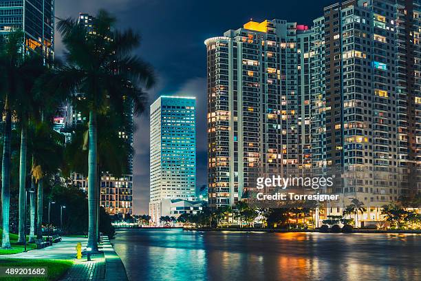 the miami city viewed from miami river at night - florida nightlife stock pictures, royalty-free photos & images