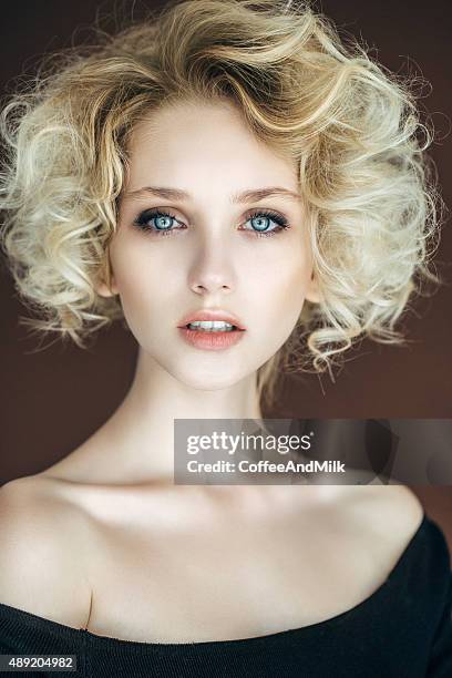 beautiful woman with stylish hairstyle - curly blonde hair stock pictures, royalty-free photos & images