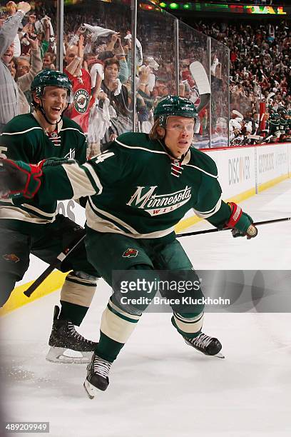 Mikael Granlund and Jonas Brodin of the Minnesota Wild celebrate after scoring a goal against the Chicago Blackhawks during Game Three of the Second...