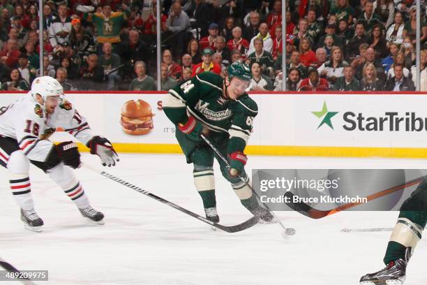 Mikael Granlund of the Minnesota Wild scores a goal with Marcus Kruger of the Chicago Blackhawks defending during Game Three of the Second Round of...