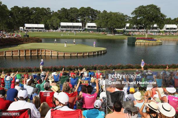 Fans cheer as Bill Haas of the United States makes birdie on the 17th green during the third round of THE PLAYERS Championship on the stadium course...