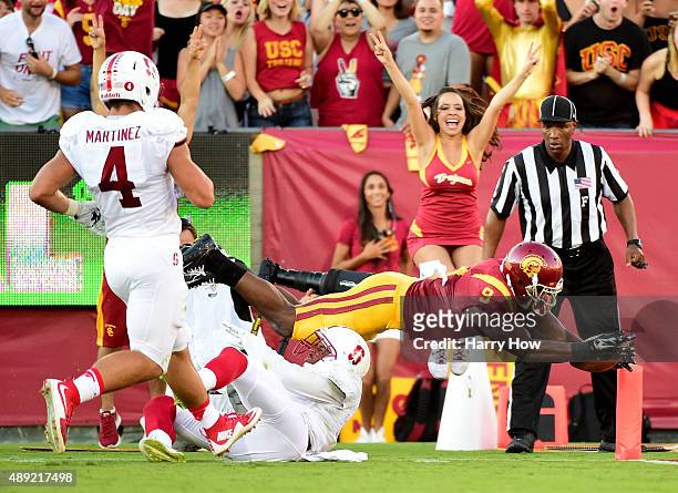 JuJu Smith-Schuster of the USC Trojans dives over Kodi Whitfield of the Stanford Cardinal for a touchdown as Blake Martinez follows the play to take...
