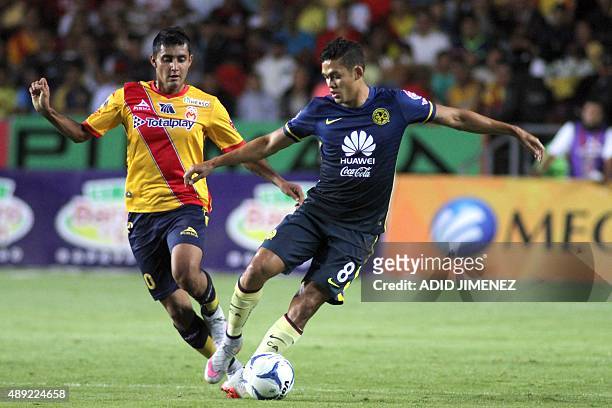Ignacio Gonzalez of Morelia vies for the ball with Andres Andrade of America during their Mexican Apertura 2015 tournament football match at the Jose...