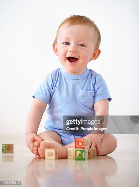 keeping himself entertained at home - baby blocks stock pictures, royalty-free photos & images