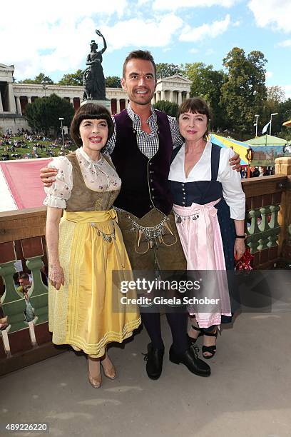 Mireille Mathieu, wearing a dirndl by Daniel Fendler, and Florian Silbereisen and sister Monique Mathieu during the Oktoberfest 2015 Opening at...