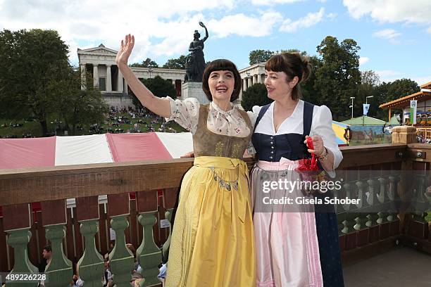 Mireille Mathieu, wearing a dirndl by Daniel Fendler, and sister Monique Mathieu during the Oktoberfest 2015 Opening at Kaeferschaenke beer tent at...