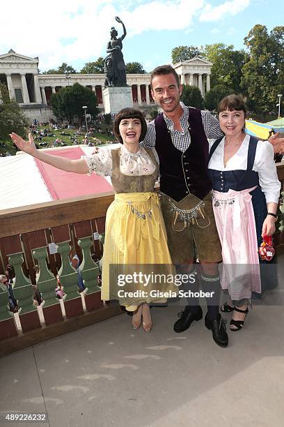 Mireille Mathieu, wearing a dirndl by Daniel Fendler, and Florian Silbereisen and sister Monique Mathieu during the Oktoberfest 2015 Opening at...