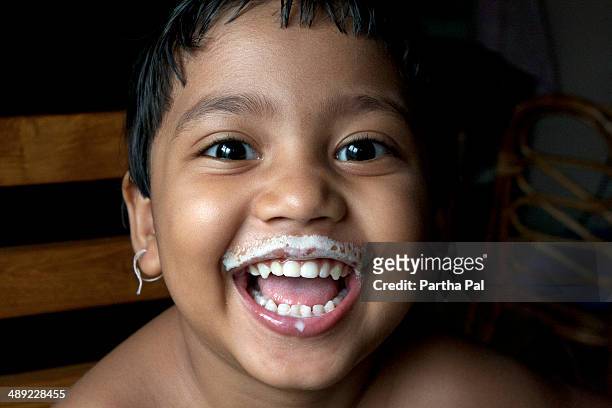 a 4 yearold indian girl after drinking milk - milk moustache stock-fotos und bilder