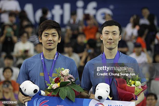 Gold medalist Lee Yong-Dae and Yoo Yeon-Seong of South Korea pose on the podium after the Men's Double final match of the 2015 Viktor Korea Badminton...