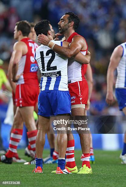 Adam Goodes of the Swans congratulates Lindsay Thomas of the Kangaroos after the First AFL Semi Final match between the Sydney Swans and the North...