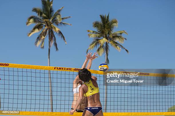 Ayumi Kusano of Japan, right, sikes the ball against Barbora Hermannova of Czech Republic during a qualification match of the 2014 FIVB Beach...