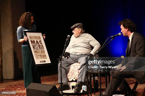 Mac Wiseman is presented with a Hatch Show Print during the Mac Wiseman Program at Country Music Hall of Fame and Museum on September 19, 2015 in...